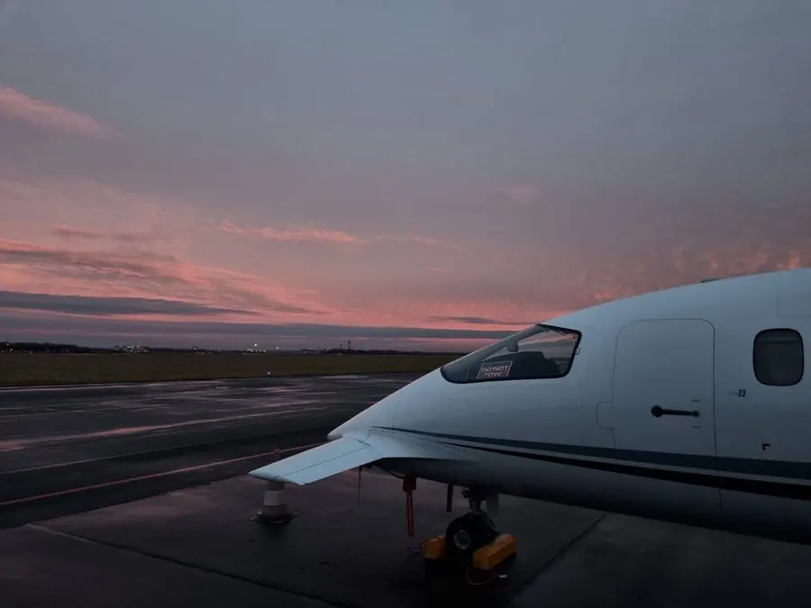 Avanti nose and cockpit at first light on a wet ramp